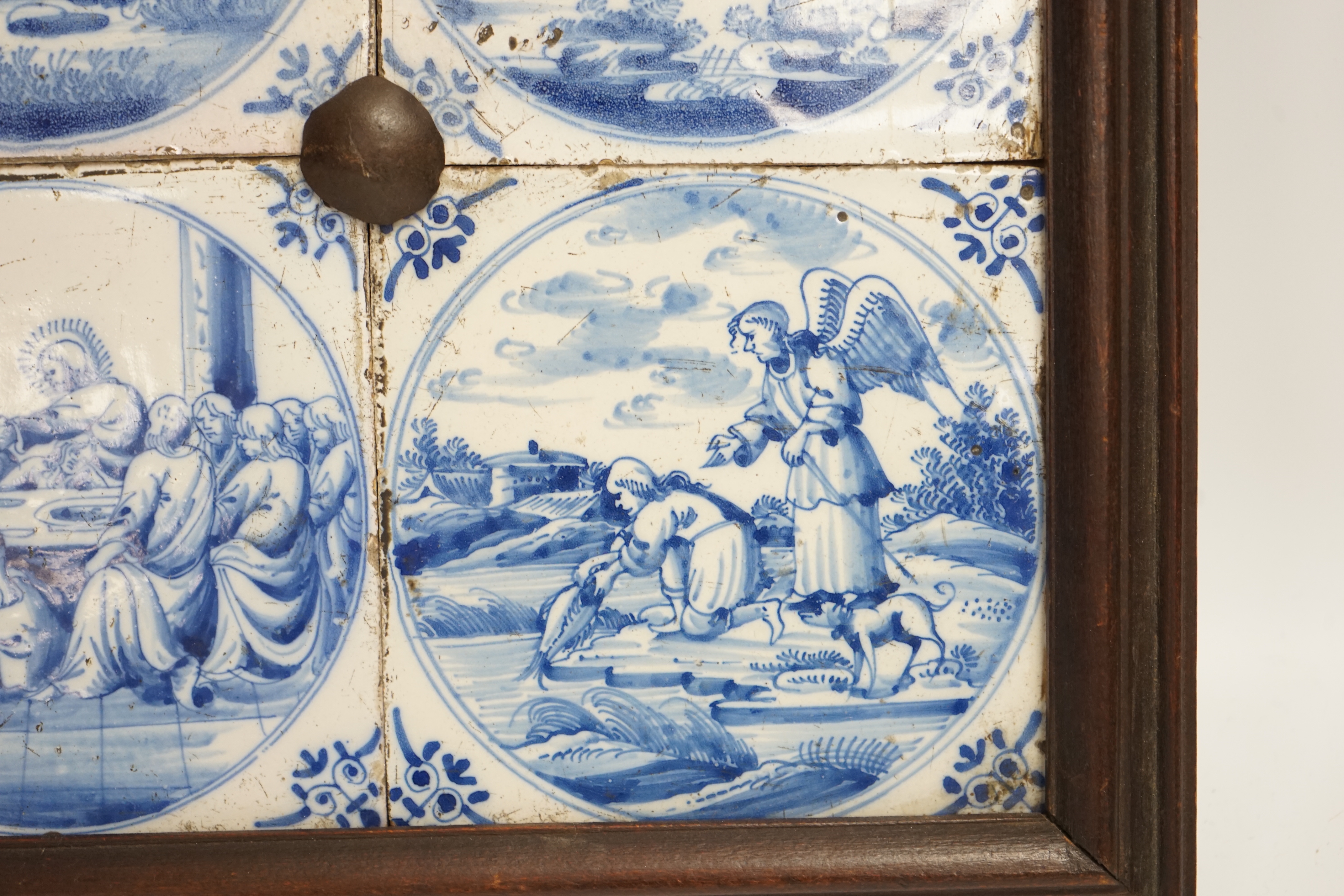 Four framed 19th century Delft ‘bible story’ tiles, 31cm x 31cm